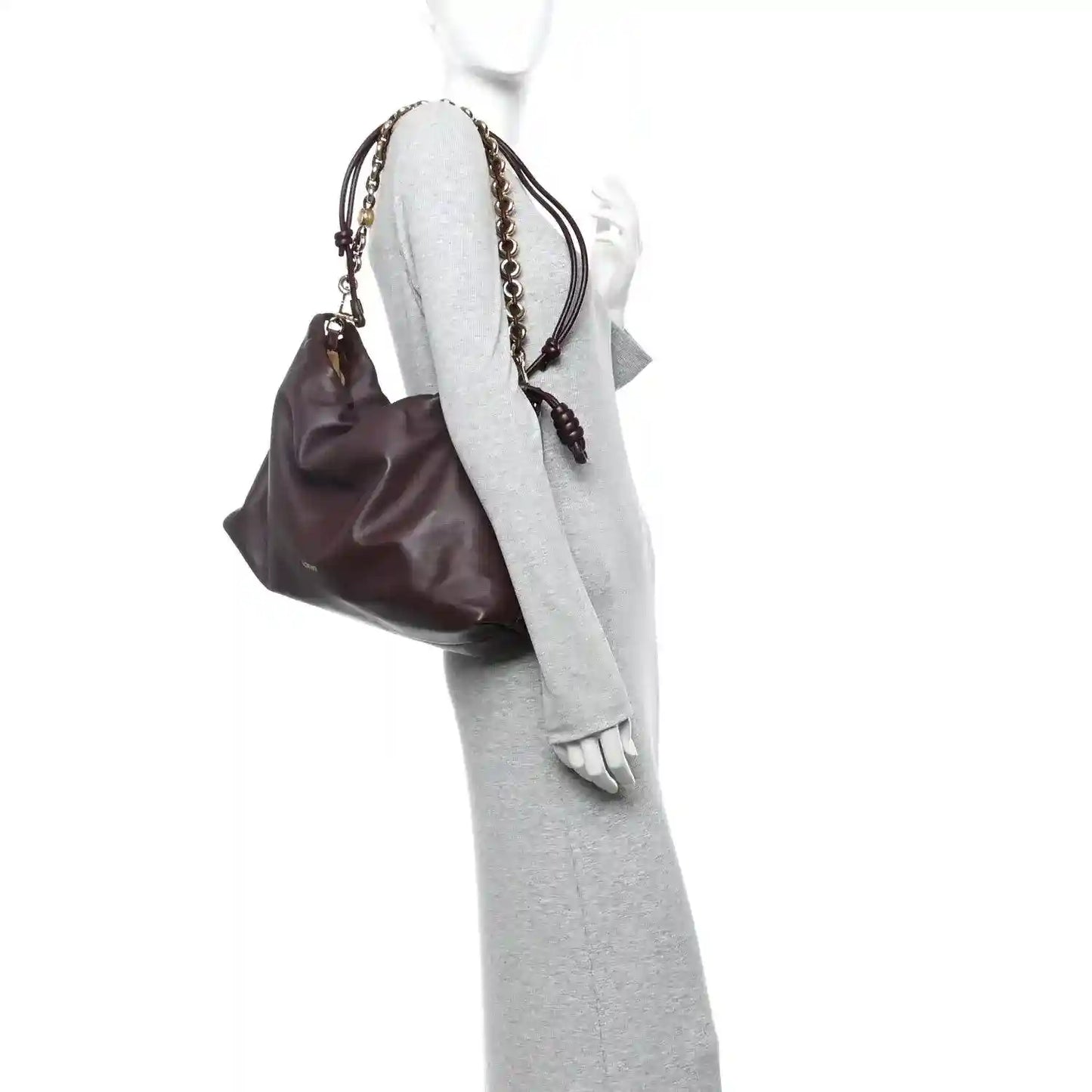 Dark burgundy leather clutch worn on mannequin with gold chain strap