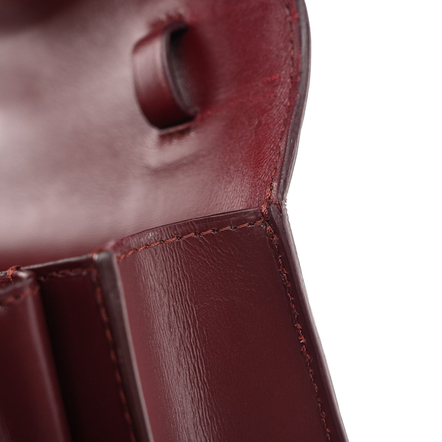 Celine burgundy leather flap area with stitched edge and boxy structure close-up