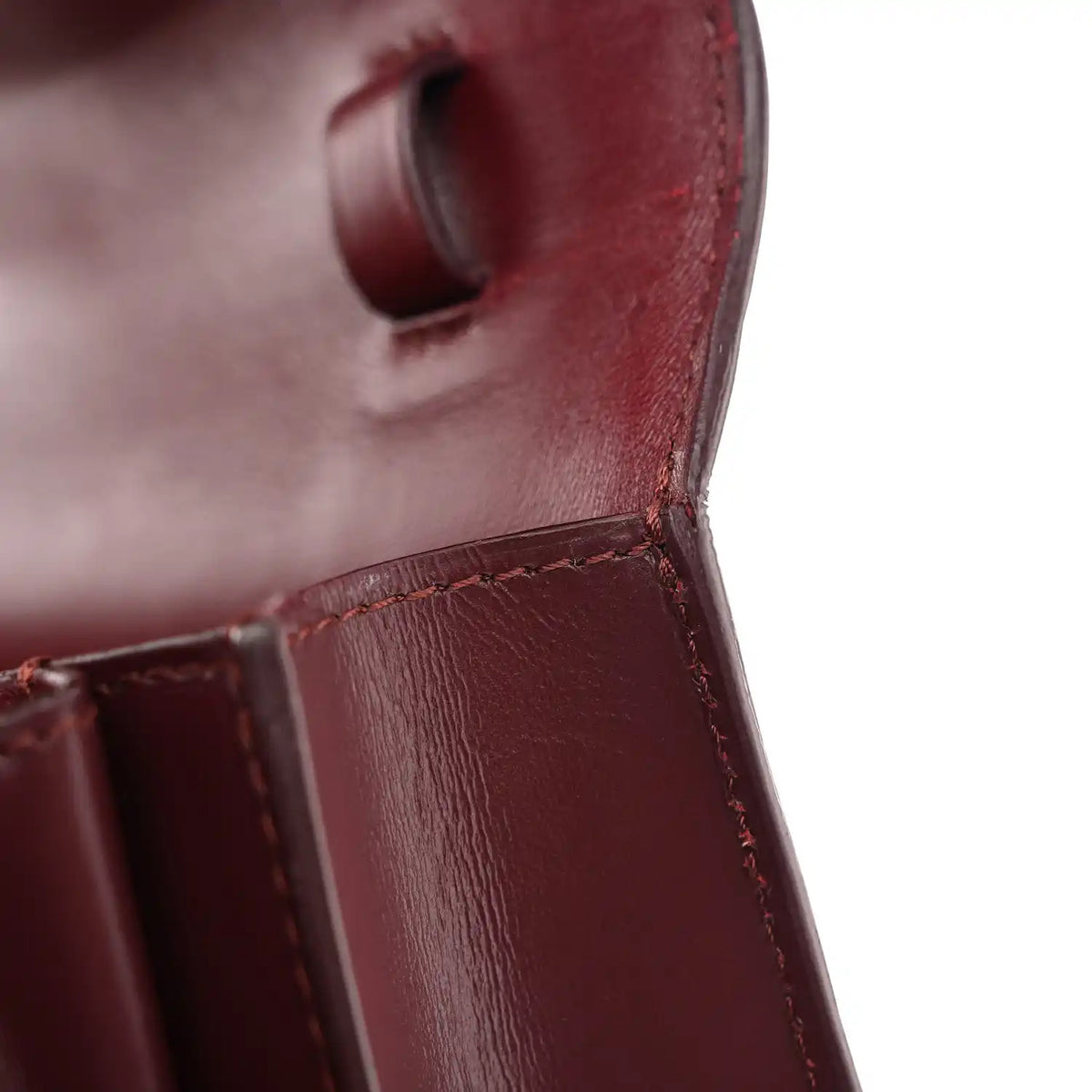 Celine burgundy leather flap area with stitched edge and boxy structure close-up