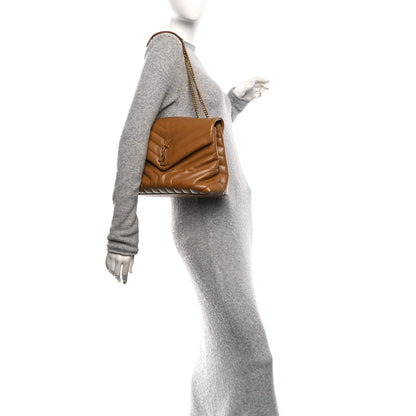 Tan leather medium satchel with chain strap, worn on a mannequin with gray outfit