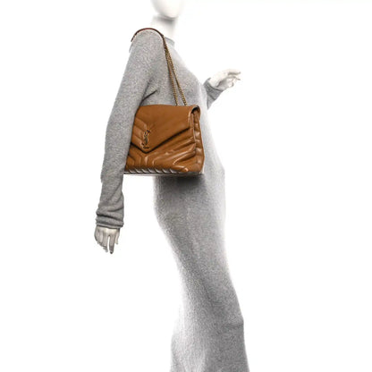 Tan leather medium satchel with chain strap, worn on a mannequin with gray outfit