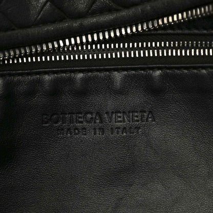 Black leather shoulder bag with gold-tone zipper and debossed logo panel