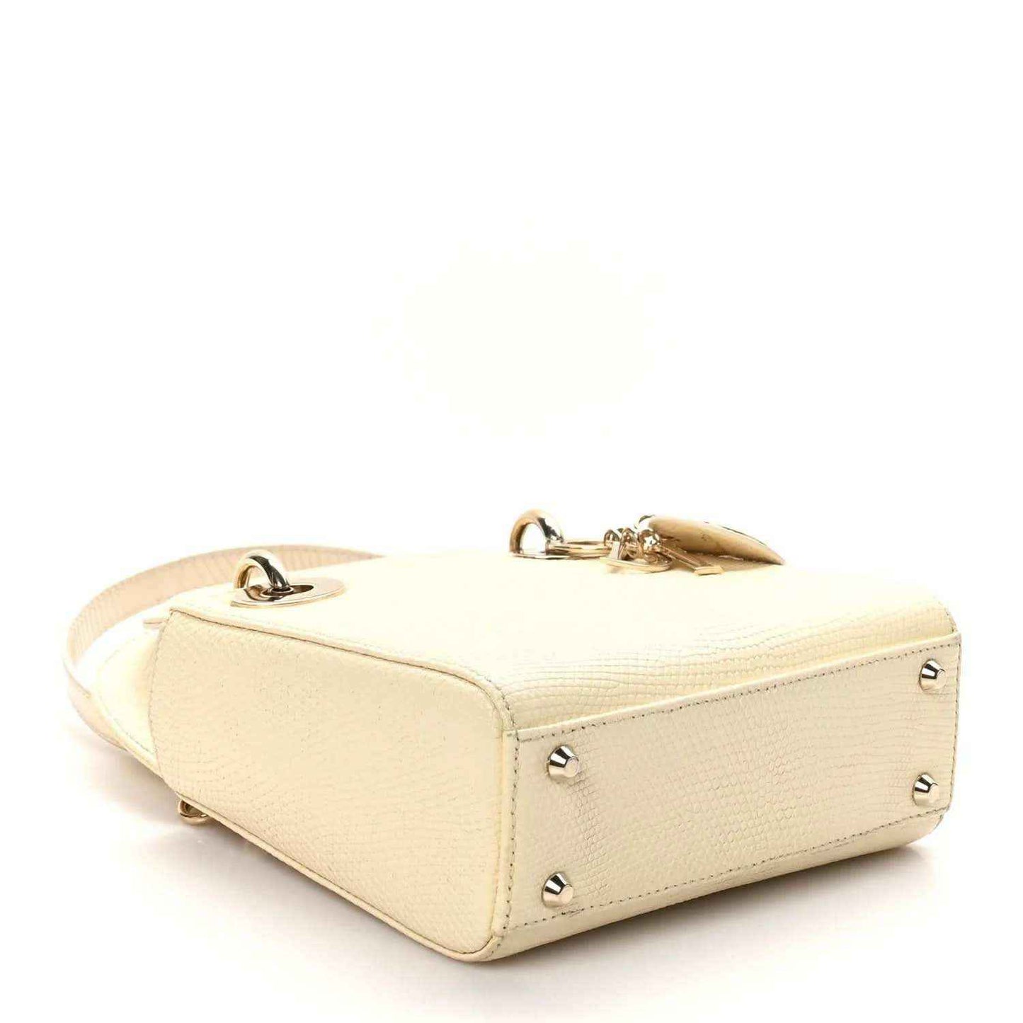 Ivory lizard mini handbag with gold zipper pull, side studs, and top handle