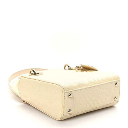 Ivory lizard mini handbag with gold zipper pull, side studs, and top handle