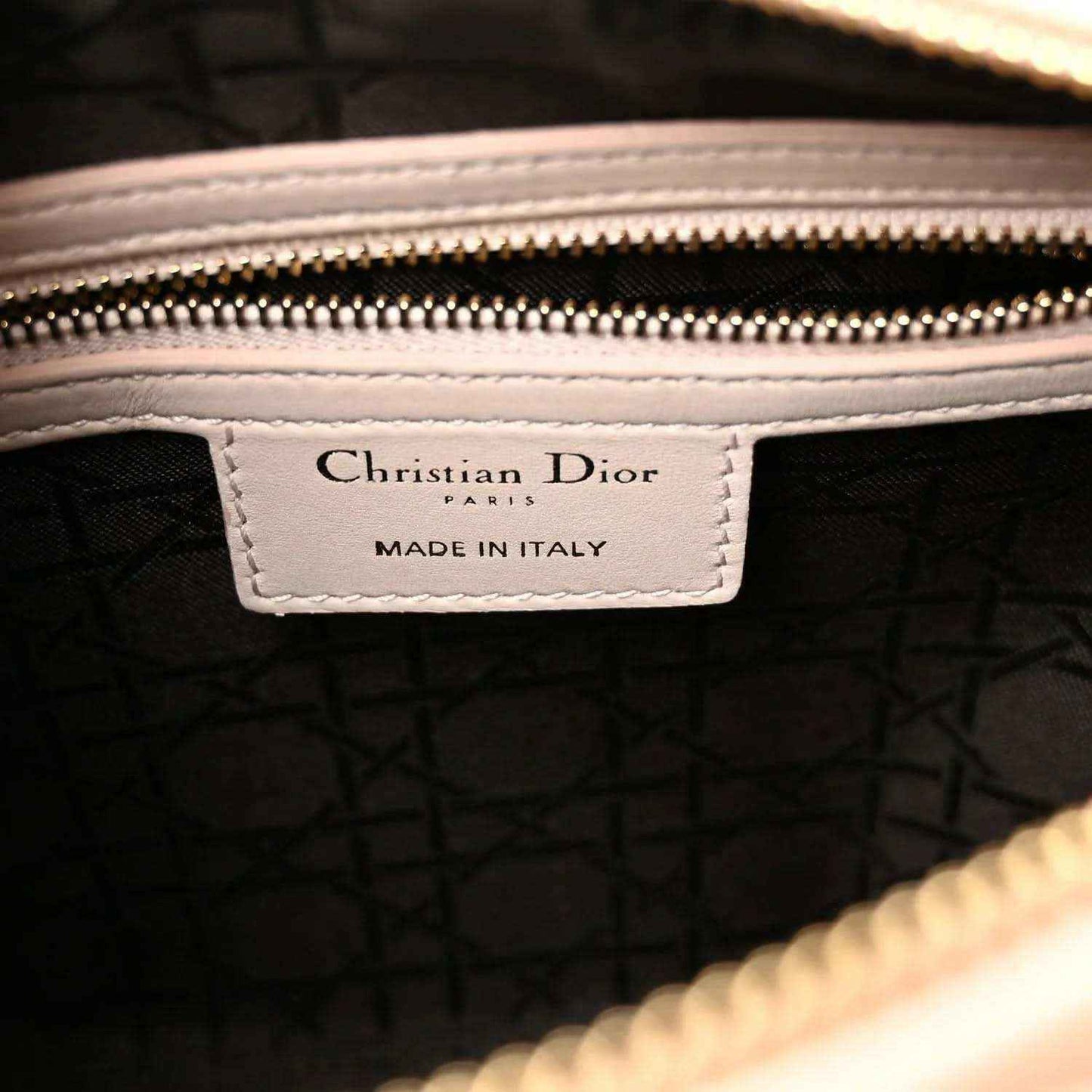 Inside label with 'Christian Dior' and 'Made in Italy' on dark fabric lining.