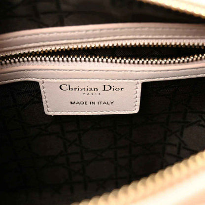 Inside label with 'Christian Dior' and 'Made in Italy' on dark fabric lining.