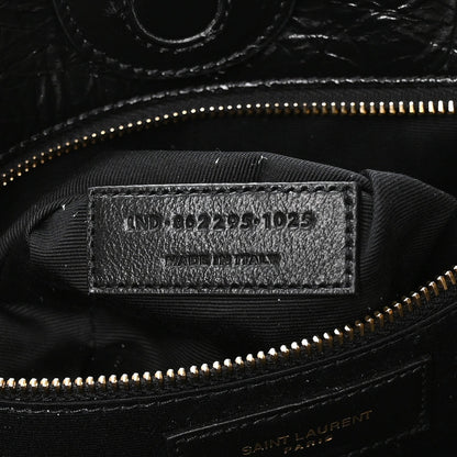 Black interior label with style code and gold zipper near top seam