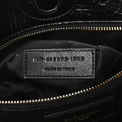 Black interior label with style code and gold zipper near top seam