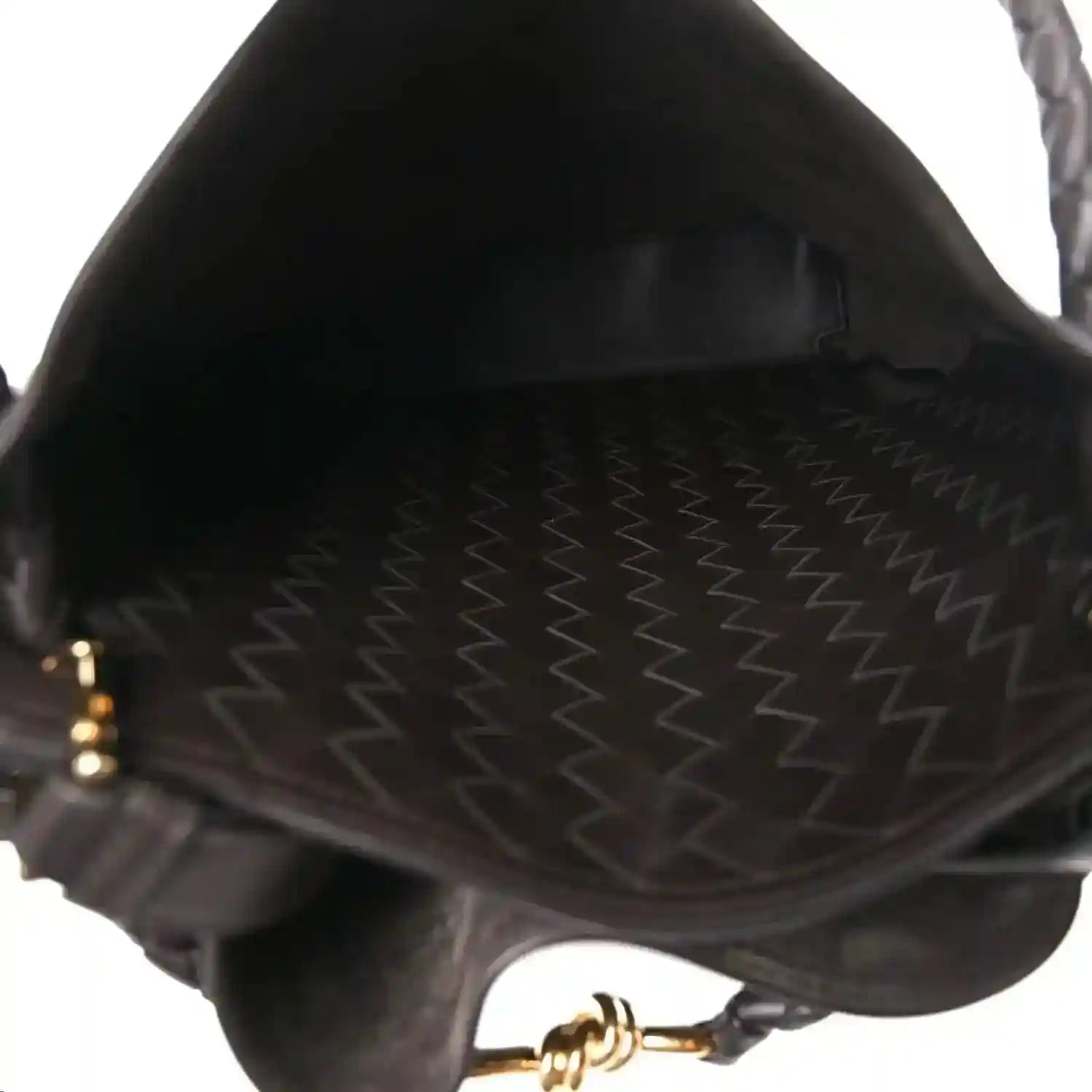 Small bucket bag interior with stitched lining and braided edge detail