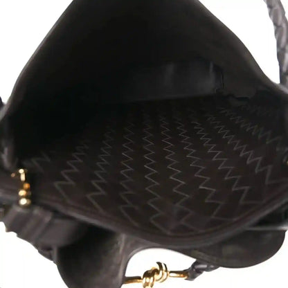 Small bucket bag interior with stitched lining and braided edge detail