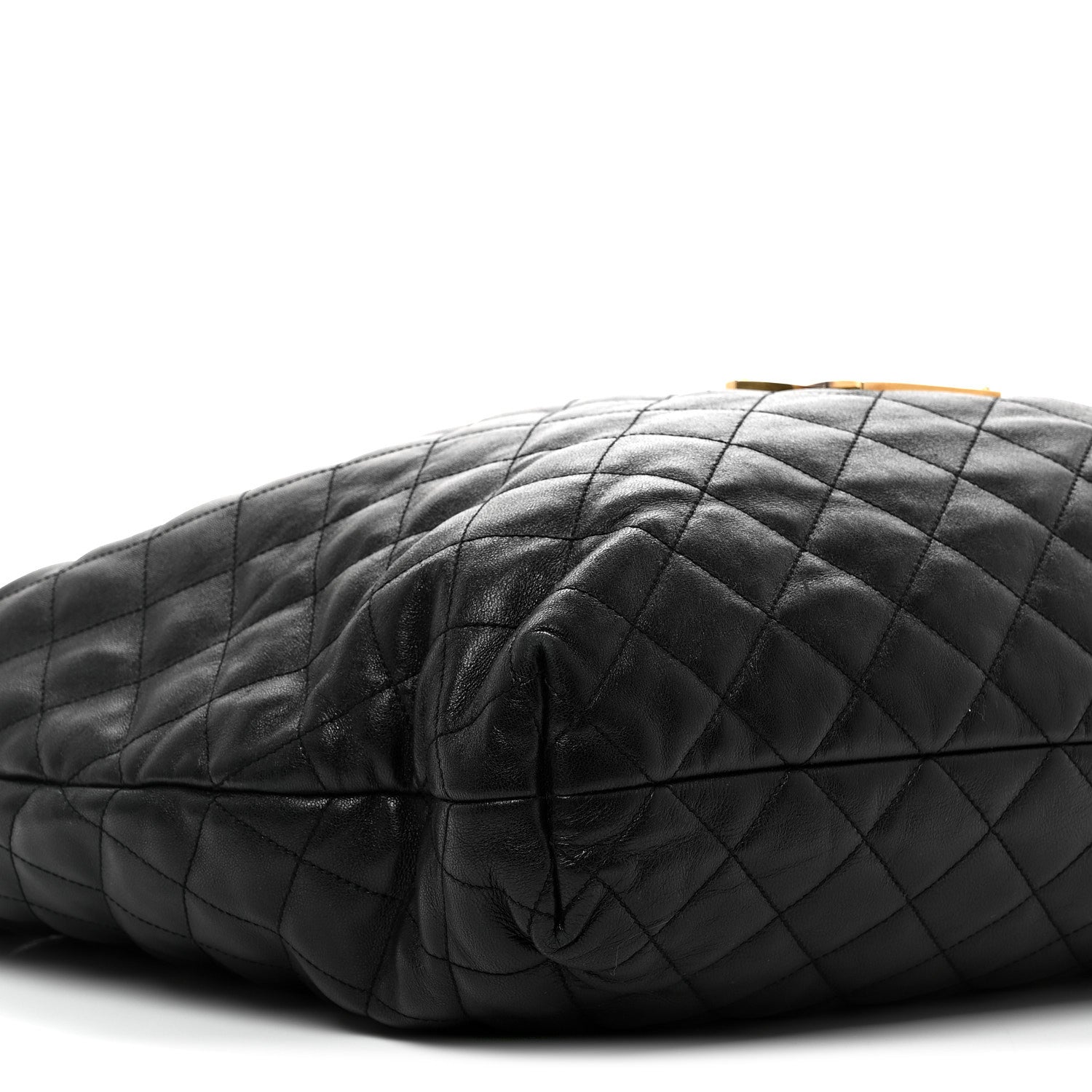 Close-up of black quilted leather top edge with YSL tote-style hardware