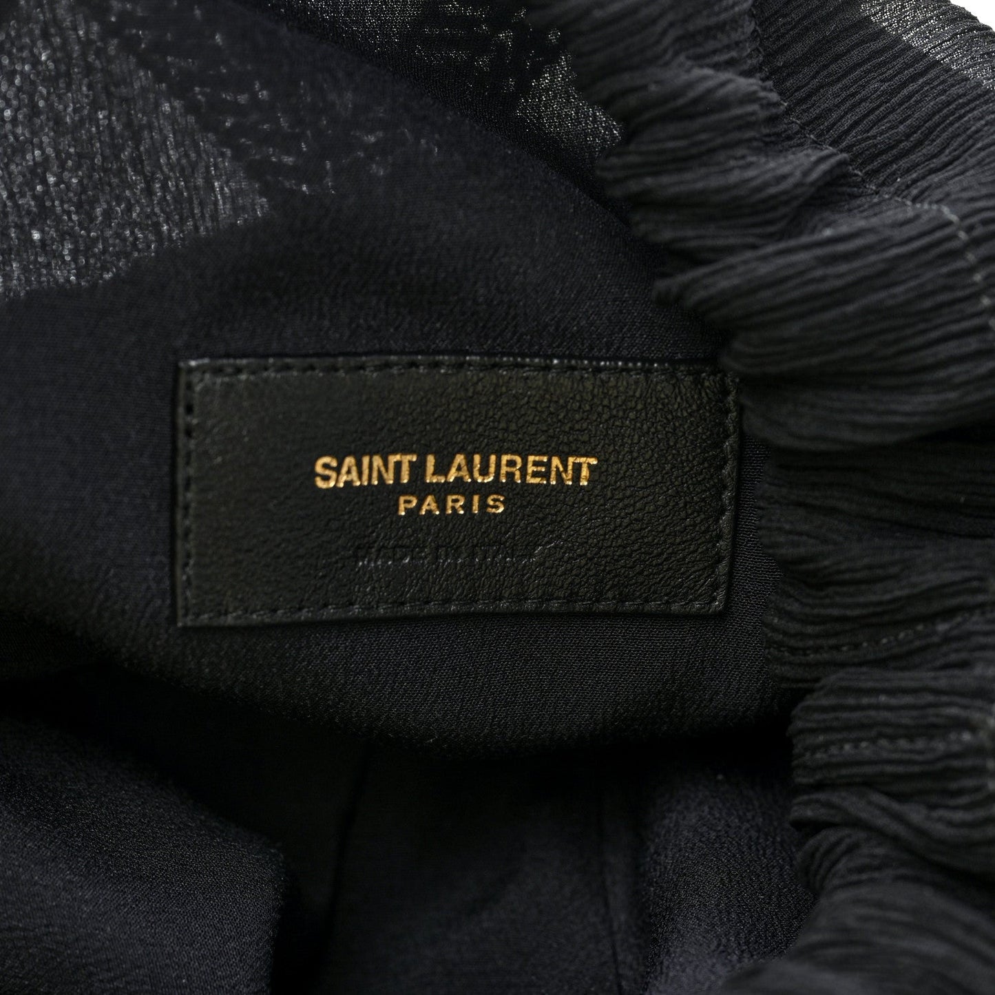 Black Saint Laurent Paris label on interior lining of beaded pochon bag