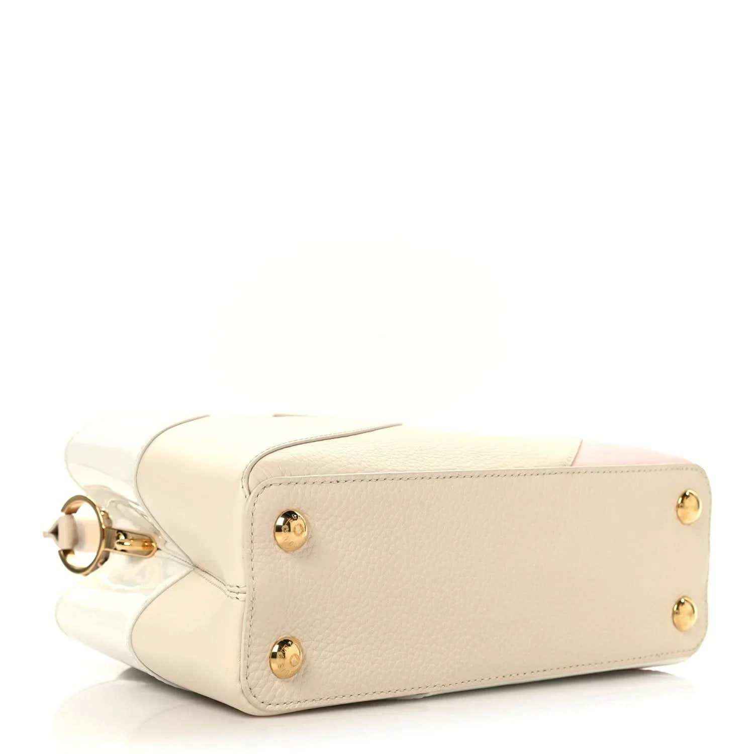 Cream leather handbag with top handle strap, gold-tone studs, and side pocket