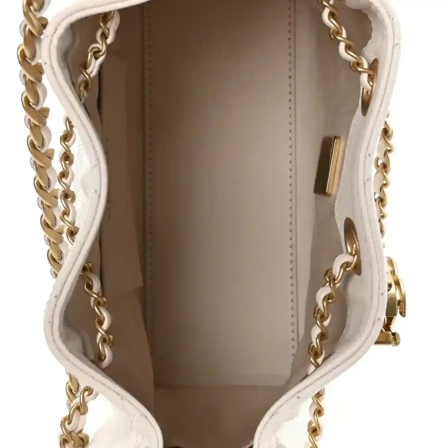 White mini handbag interior with brown lining and gold trim near the side wall