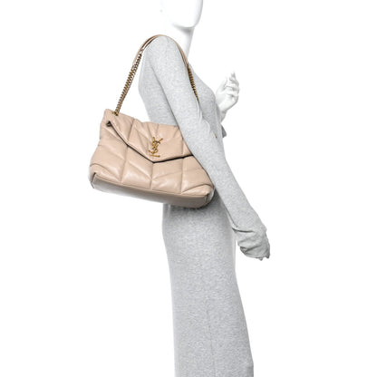 Dark beige quilted satchel on chain strap, shown from side on a model