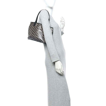 Reversible mini tote bag held at side on model, black-and-gray patterned canvas