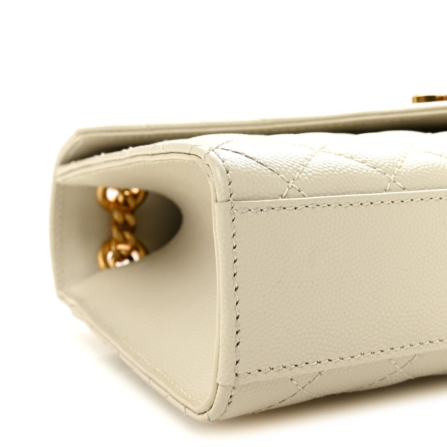 Cream quilted satchel corner with gold chain connector and side opening