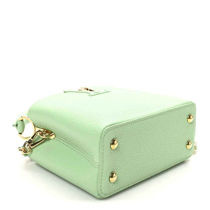 Green leather mini handbag with gold-toned feet on base