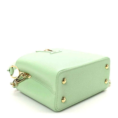 Green leather mini handbag with gold-toned feet on base