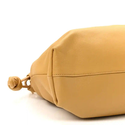 Tan nappa leather clutch with drawstring cord, side seam, and knot detail