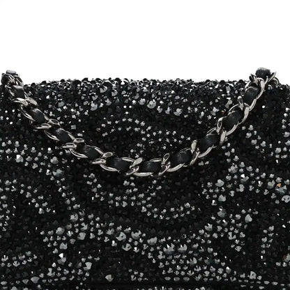 Black rhinestone small flap bag front with silver-tone chain detail across top