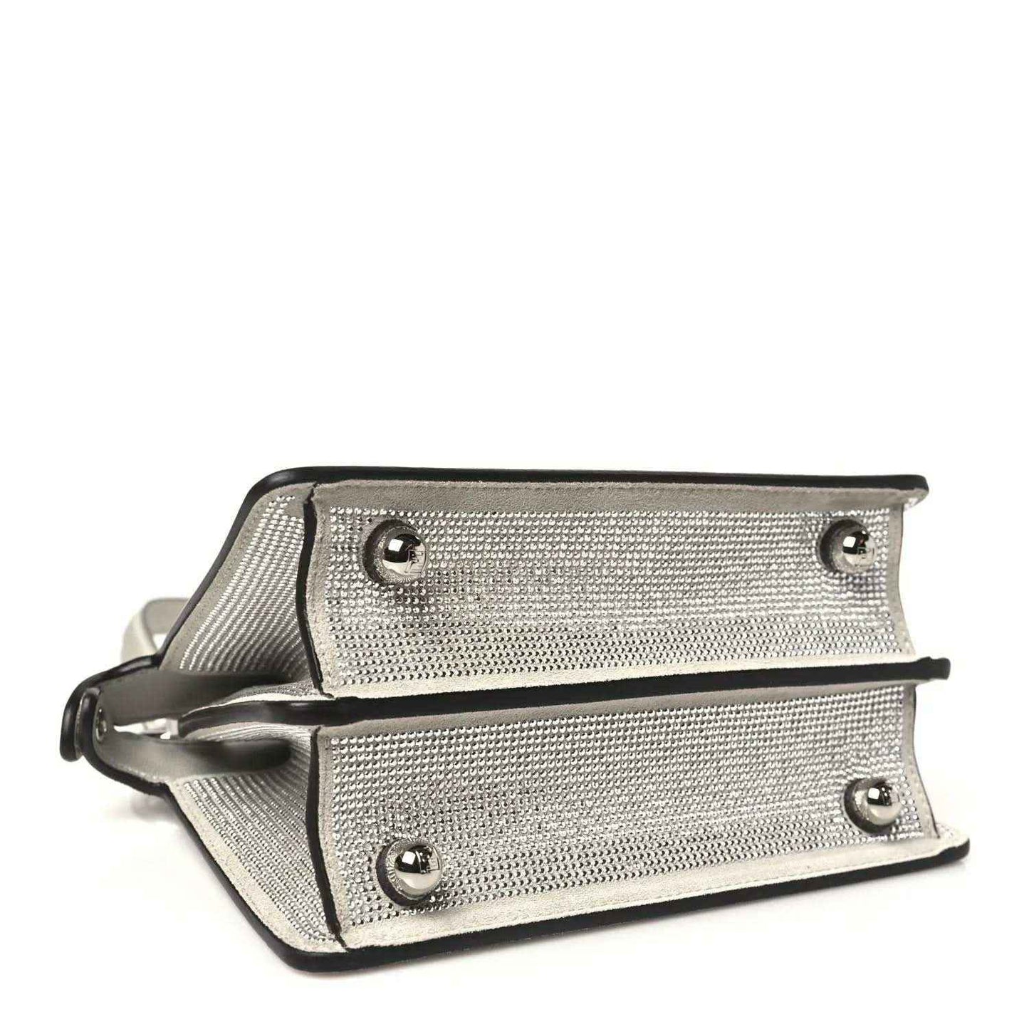 Small satchel bottom view with two rows of studs, snap closure, and contrast trim