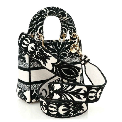 Mini embroidered canvas bag with floral-and-bar pattern, gold-tone hardware and handles