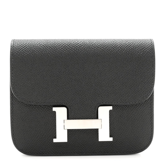 Black slim wallet with front H clasp in palladium-tone metal.