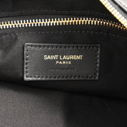 Saint Laurent Paris leather label on black hobo bag with gold zipper trim