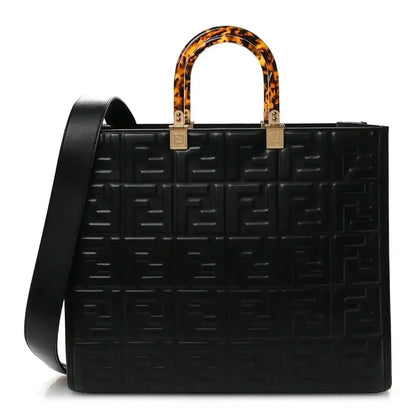 Black leather tote bag with embossed FF pattern, tortoise handles, gold hardware