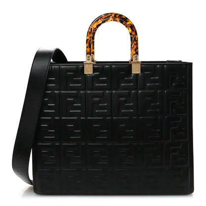 Black leather tote bag with embossed FF pattern, tortoise handles, gold hardware