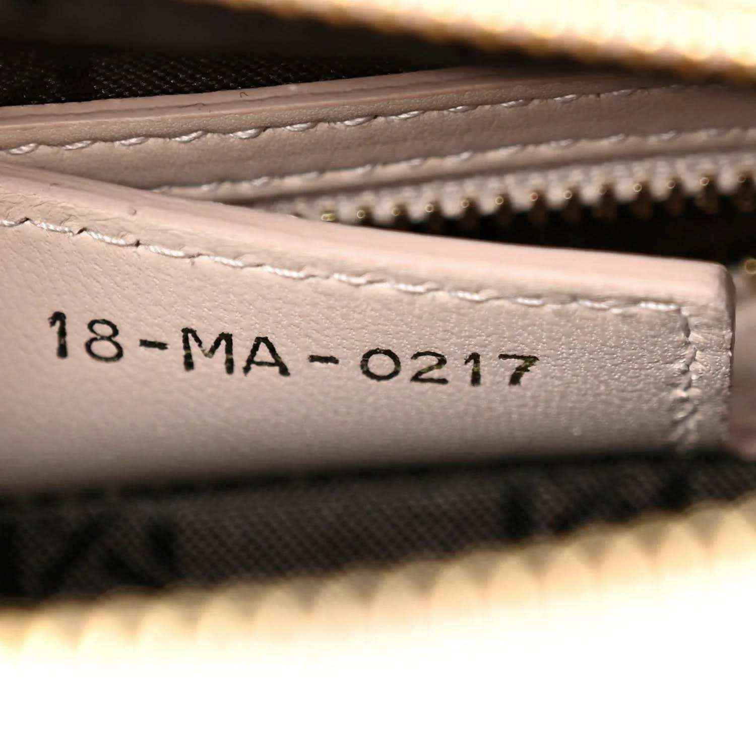 Beige leather serial stamp '18-MA-0217' on inside pocket lining.