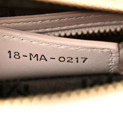 Beige leather serial stamp '18-MA-0217' on inside pocket lining.