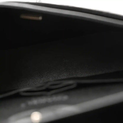 Small quilted lambskin flap bag interior, black lining and flap detail