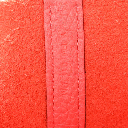 Rose pink leather strap section with embossed text and stitching detail
