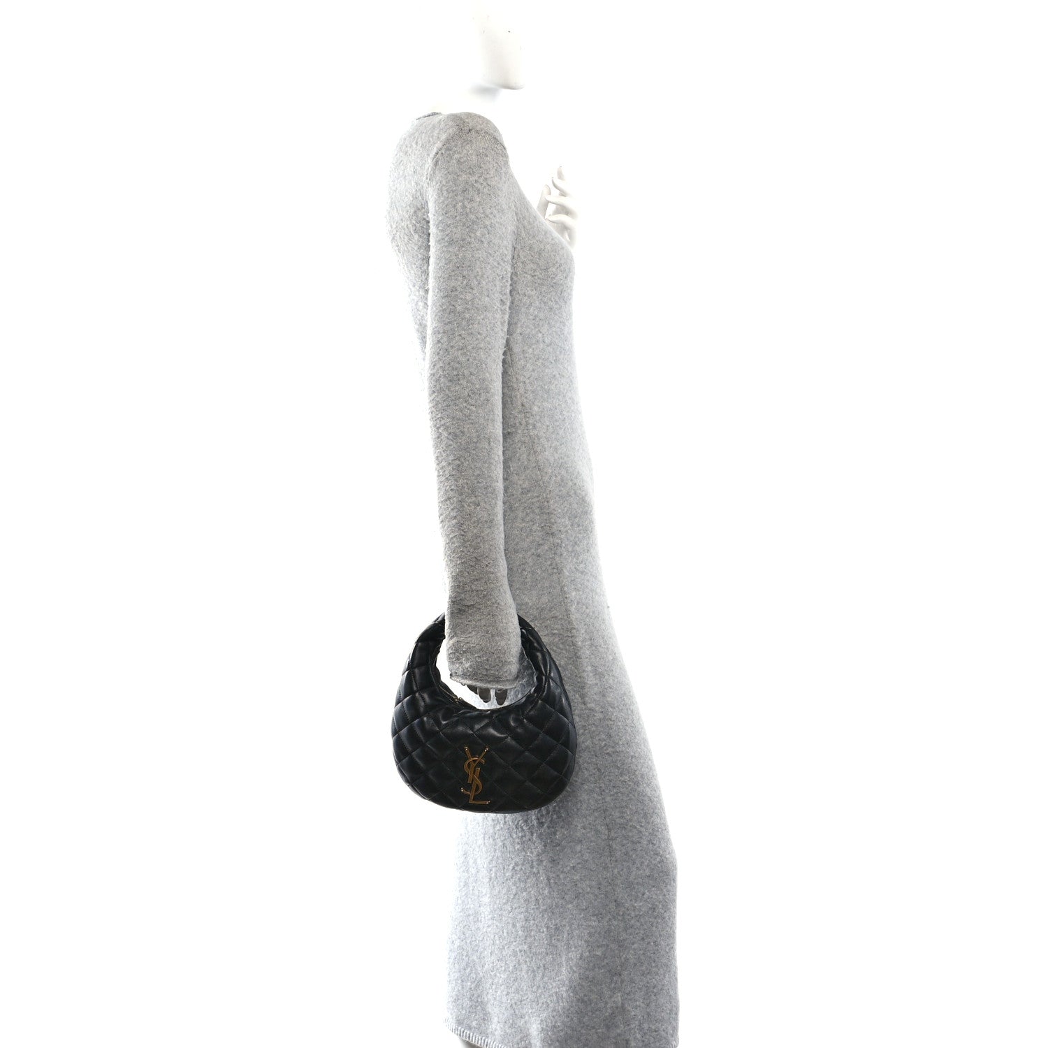Black mini pouch charm attached near the top handle of the bag