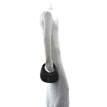 Black mini pouch charm attached near the top handle of the bag