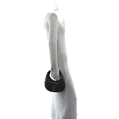 Black mini pouch charm attached near the top handle of the bag