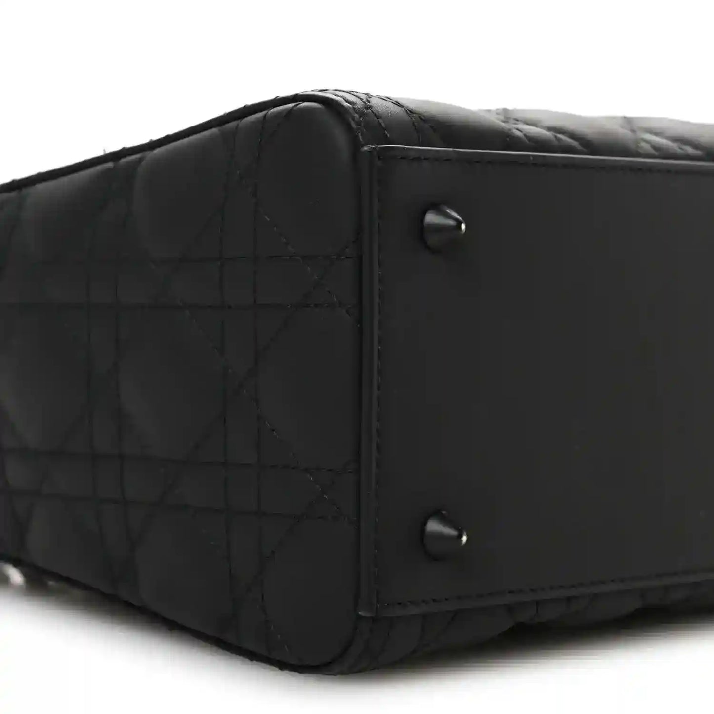 Black Lady Dior handbag side with quilted panel and metal rivets
