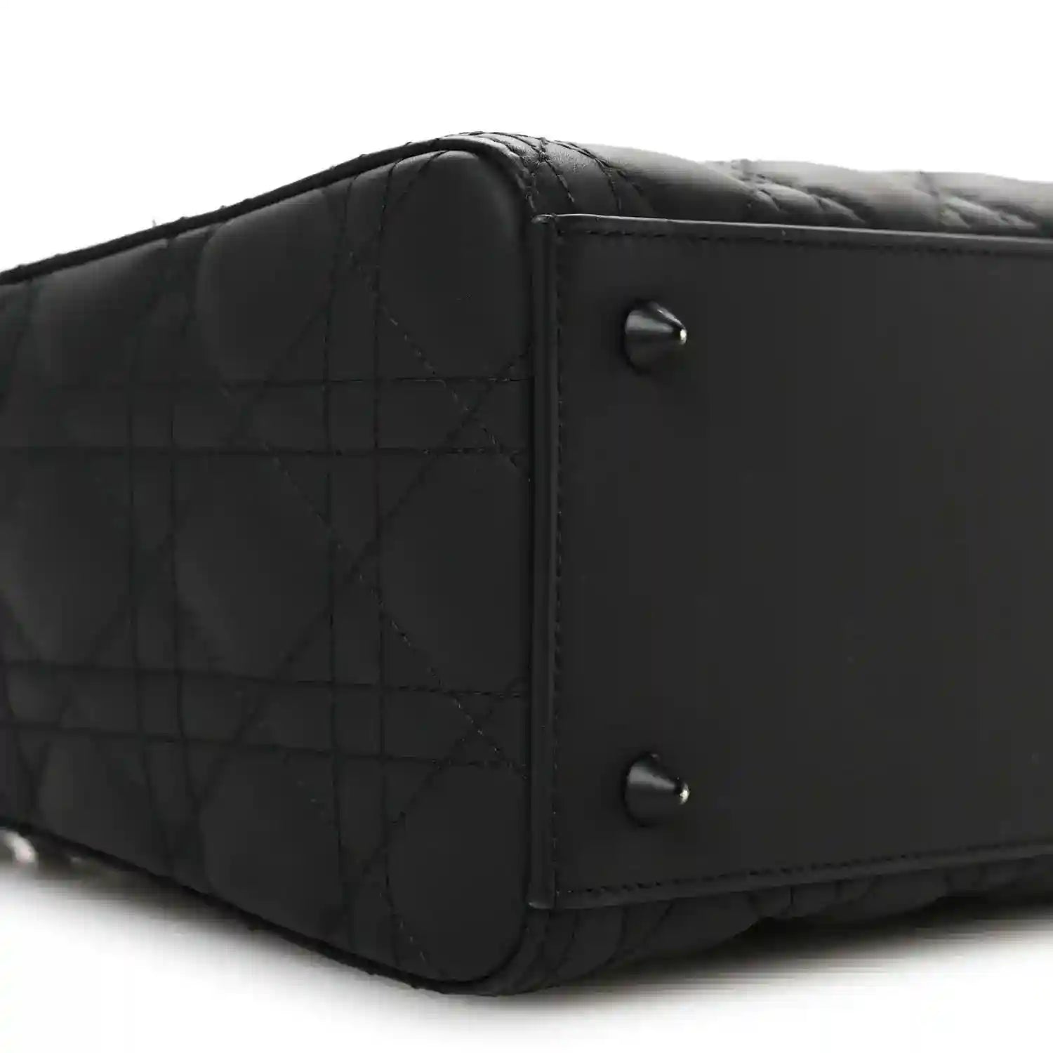 Black Lady Dior handbag side with quilted panel and metal rivets