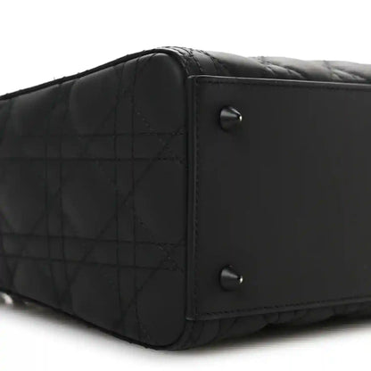 Black Lady Dior handbag side with quilted panel and metal rivets