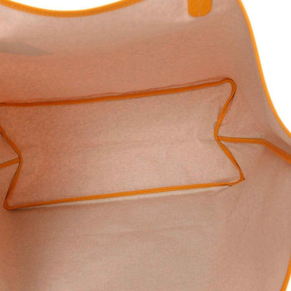 Yellow canvas tote bag interior lining with orange-stitched seams
