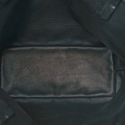 Black leather-like interior pocket panel of a reversible mini tote bag with seams.