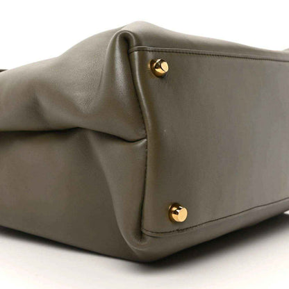 Cypress calfskin handbag corner with two gold snap buttons