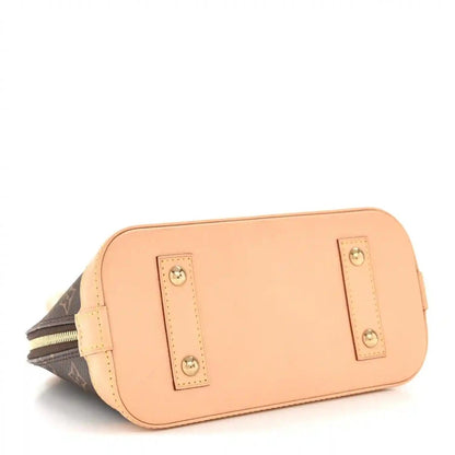 Small monogram tote bag back panel with tan leather slip pocket and gold hardware