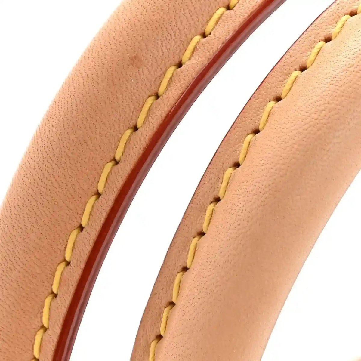 Tan leather strap seam detail with yellow stitching on monogram tote bag