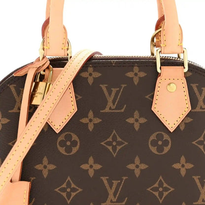 Monogram tote bag front view with tan leather strap ties, handles, and gold clasp