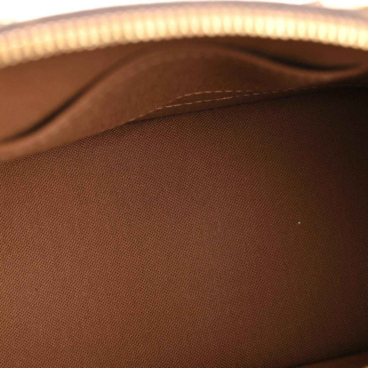 Monogram tote bag interior fabric close-up in dark brown