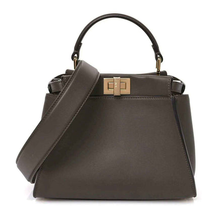 Mini Peekaboo satchel in dark chocolate brown leather, gold clasp and top handles.