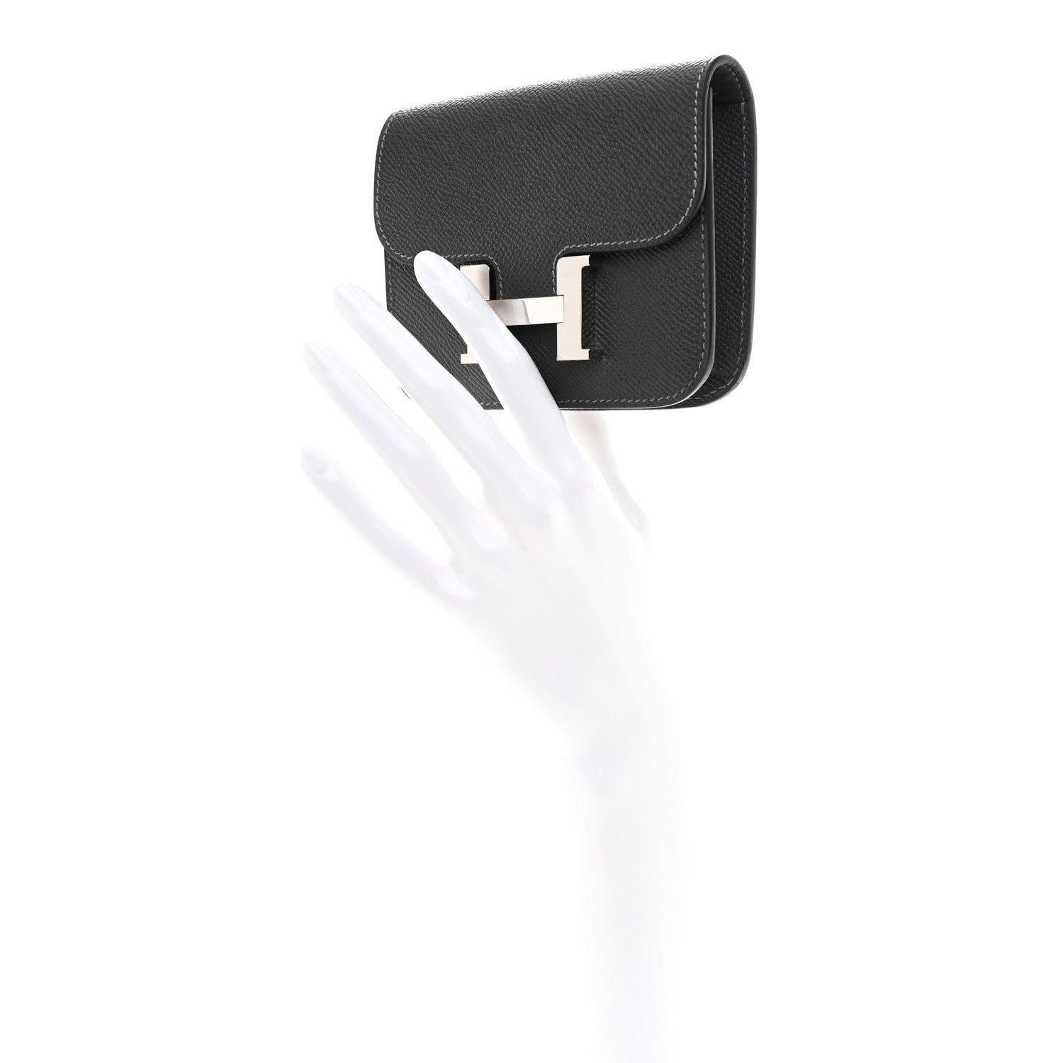 Constance slim wallet with H clasp in dark leather, angled side view